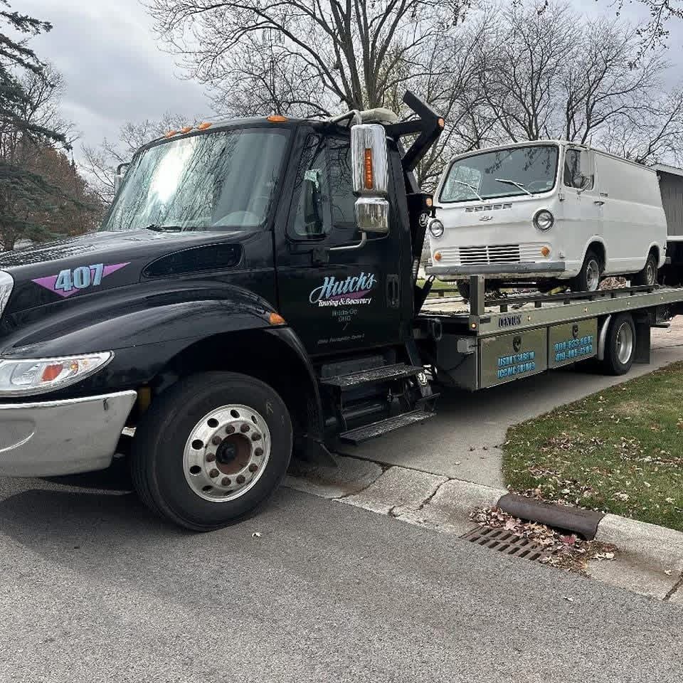 Hutch's flatbed transporting a vintage van